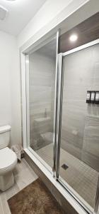 a bathroom with a glass shower with a toilet at Muskoka Luxury Getaway in Gravenhurst