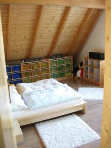 a bedroom with a bed and two rugs in a attic at Villa Domus in Krems an der Donau