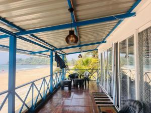 a view of the beach from the porch of a house at Tejas Beach View Stay Talpona in Canacona