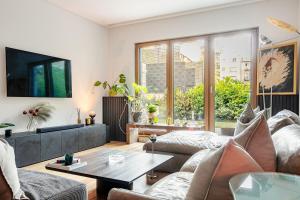 a living room with a couch and a table at Garden Oasis in City Center in Belgrade
