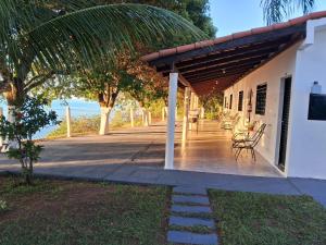 a porch of a white building with a view of the ocean at Associação Sabesp Presidente Epitácio in Presidente Epitácio