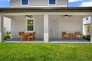 a patio with chairs and a table on a house at Inviting Home Near Disney With Waterpark & Resort Access At Encore Resort - 7792Sw in Kissimmee