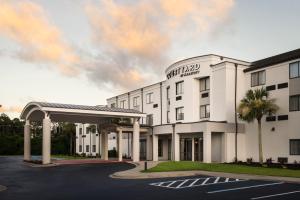 a rendering of the front of a hotel with a parking lot at Courtyard Brunswick in Brunswick