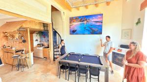 a group of people standing in a room with a pool table at Gîte familial Détente entre Loir et coteau, spa-sauna, acc pmr in Les Roches-lʼÉvêque