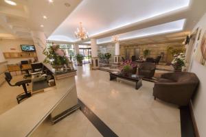 a lobby with couches and chairs and a reception desk at Hotel Plaza Mayor in Santo André