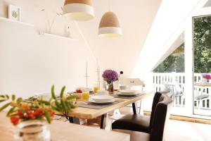 une salle à manger avec une table et des chaises en bois dans l'établissement Im Bad, strandnah und zentral, à Sankt Peter-Ording