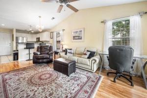 a living room with a couch and a table at 59-E Tee TIme Escape condo in True Blue +9 photos