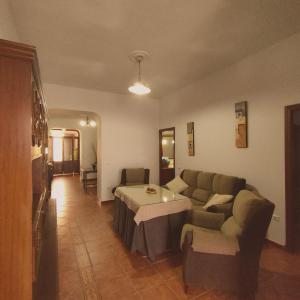 a living room with a couch and a table at AT Casa Pedrero in Fregenal de la Sierra