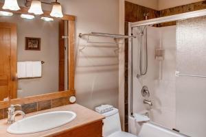 a bathroom with a toilet sink and a shower at Snowbanks 6 in Big White +26 photos