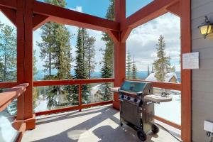 a grill on a screened in porch with a view at Snowbanks 6 in Big White