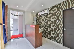 a room with a wooden door and a wall at Hotel Infinity in Vadodara