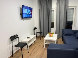 a living room with a blue couch and chairs at Golondrinas de Alicante in Alicante