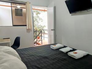 a bedroom with a bed with two towels on it at Samanai Wasi in Lima