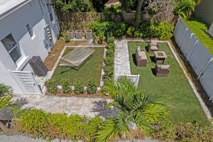 an aerial view of a garden with a bench and tables at Pineapple Paradise #3 13 min to Beach Fire Pit in Sarasota