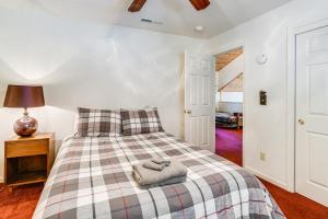 a bedroom with a bed with a plaid blanket at Hike, Swim, Golf Family Retreat in Arnold! in Arnold +19 photos