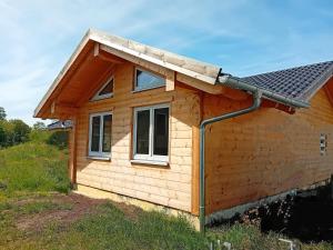 a small house with a pitched roof at Ferienhaus 4 Elemente in Selchow mit tollem Garten in Selchow