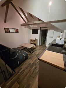 a room with wooden floors and a room with a table at L'appartement Tranquille in Maincy +11 photos