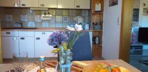 a kitchen with a table with a vase of flowers at Fewo Steinbeisser in Arrach