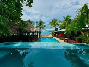 a swimming pool with a view of the ocean at Skully's Hostel in La Gruta