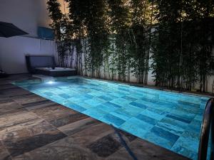 a swimming pool with blue tiles on the floor at Marshall property in Tangier