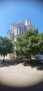 a large white building with trees in front of it at Beige Harmony in Smederevo