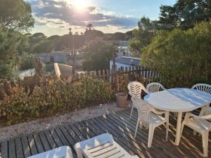 a patio with a table and chairs on a deck at Mobil home à louer dans camping des cigales le muy 5 étoiles in Le Muy