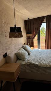 a bedroom with a bed and a window at Shalash 2 in Velikiye Lazy