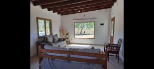 a living room with a couch and a table at Quinta Verde Alojamiento Rural in Marcos Paz