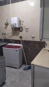 a kitchen with a sink and a bucket at شعبان in Beni Suef