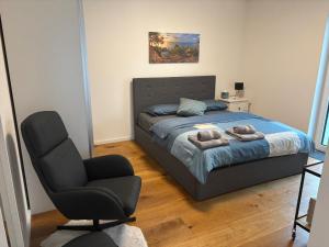 a bedroom with a bed and a chair in it at Beautiful Apartment with a huge private terrace in Speinshart