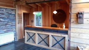 a wooden cabin with a bar in a room at Hostería Las Cumbres in Villa La Angostura