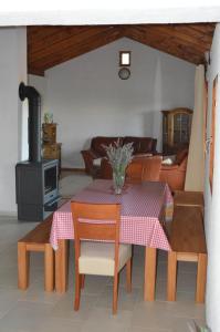 een woonkamer met een tafel en een fornuis bij Villa Mara - secluded house with breathtaking view- Seline, Starigrad Paklenica in Seline