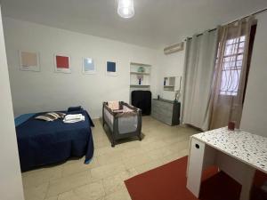 a bedroom with a bed and a television in it at Mimosa House Torino in Turin