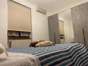 a bedroom with a bed with two pillows on it at Mimosa House Torino in Turin