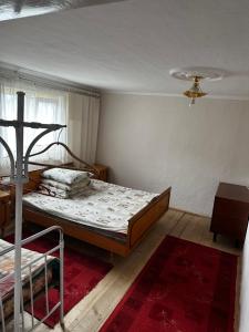 a bedroom with a bed and a ceiling at Затишний будинок in Vorokhta
