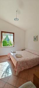 a bedroom with a large bed with a window at Villa Calatafimi Segesta in Calatafimi