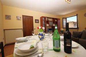 a table with a bottle of wine and glasses on it at Sunrise in Baveno - Happy Rentals in Baveno