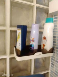a shelf in a bathroom with bottles of milk at La minisuite de Goxua in Llodio