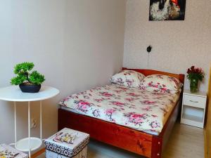 a small bedroom with a bed and a table at Comfortable holiday homes with terraces in Przewłoka