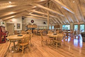 a dining room with wooden tables and chairs at Deck and Game Room! Lakefront Blue Ridge Mtn Gem in Powderhorn Mountain