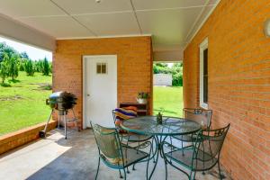 a patio with a table and chairs and a grill at 8 Mi to Clemson Peaceful Family Home with Yard in Seneca