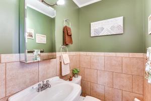 a bathroom with a sink and a toilet at 8 Mi to Clemson Peaceful Family Home with Yard in Seneca +16 photos