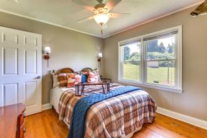 a bedroom with a bed and a window at 8 Mi to Clemson Peaceful Family Home with Yard in Seneca