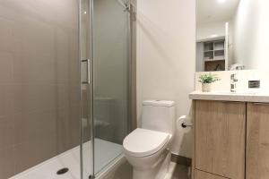 a bathroom with a toilet and a glass shower at Studio At The Crescent Sleeps 2 to 4 in Rossland
