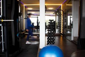 a person in a gym with a blue ball at Antonio's Hotel e Spa - Airport in Brasília +184 photos