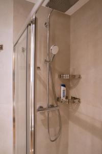 a shower with a shower head in a bathroom at La Suite Parisienne in Paris +40 photos