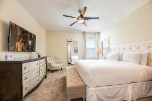a bedroom with a white bed and a ceiling fan at Gorgeous Home With Media, Disney Themed Kids Room Near Disney With Waterpark & Resort Access At Encore Resort - 771La in Kissimmee