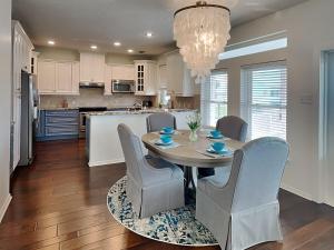 a kitchen with a dining room table and chairs at West Bay Getaway in Galveston