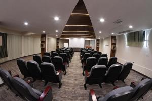 a conference room with black chairs in a building at CAR Sport Hotel Titikaka in Huarina