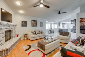 a living room with a couch and a fireplace at Pool, Spa and Mountain Views Apple Valley Retreat! in Apple Valley